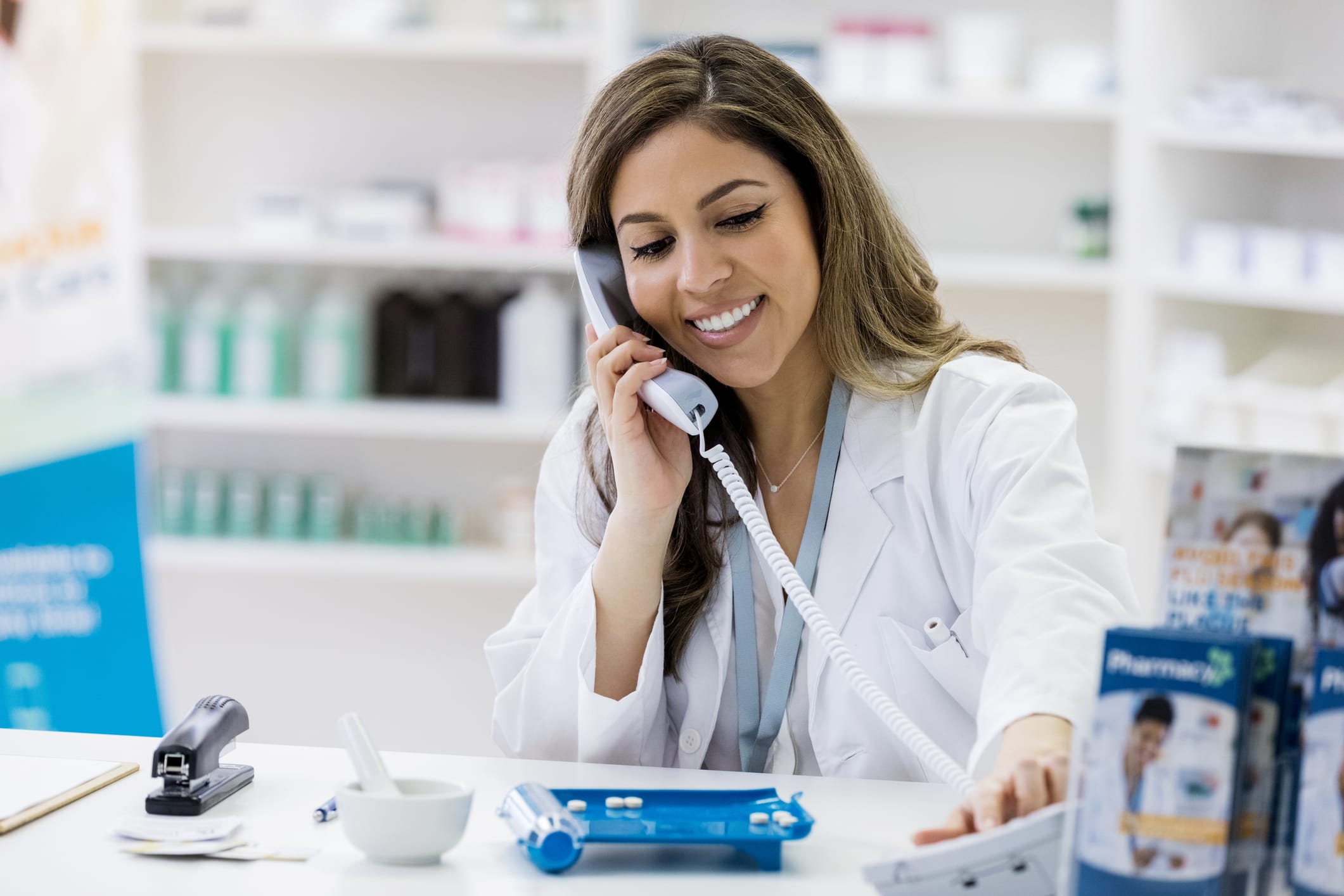 Woman in medical coat on phone in a medical office